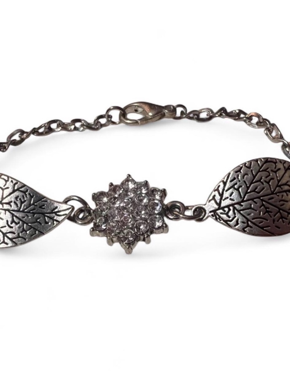 Silver leaf bracelet with rhinestone flower and leaf charms.